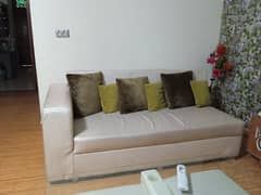 white rexine sofa with green cushions