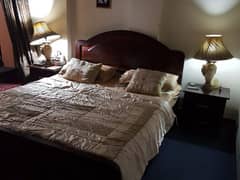 Queen Size Bed (mattress included) with Side Tables and lamps.