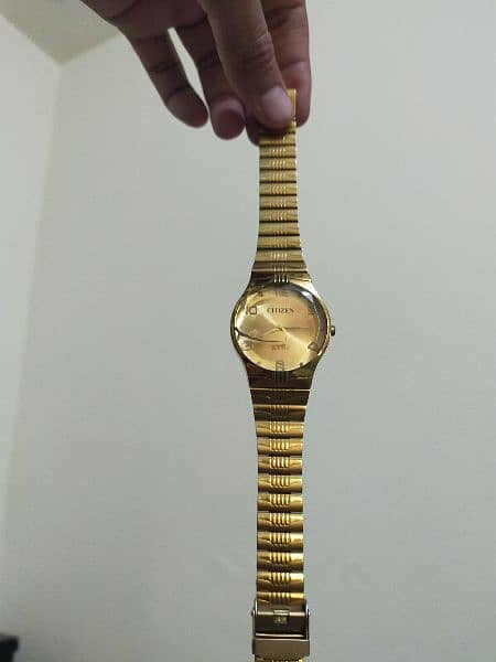 golden color citizen watch 0