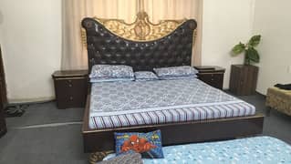 BEAUTIFUL WOODEN BED WITH ARTWORK AT TOP FOR SALE.
