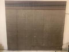 brownish curtain with design on top