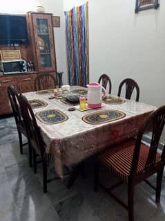 wooden dining table with six chairs.