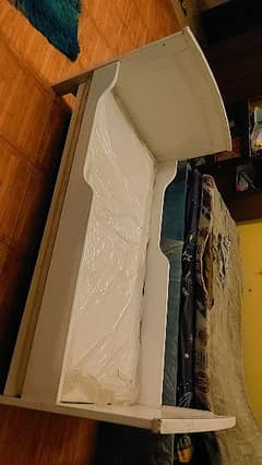 white wooden cot-cum-single bed