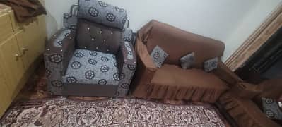 5 seater sofa set slightly used wooden with cover on it