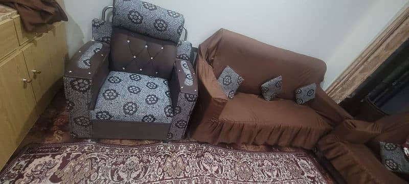 5 seater sofa set slightly used wooden with cover on it 0