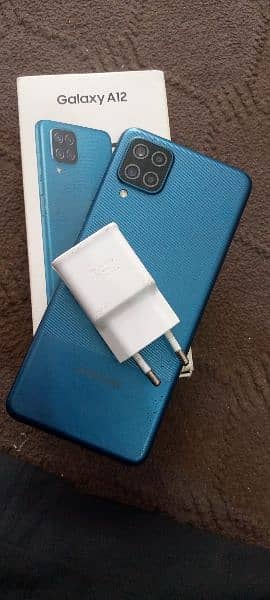 Samsung galaxy a12 box and charging adopter 1