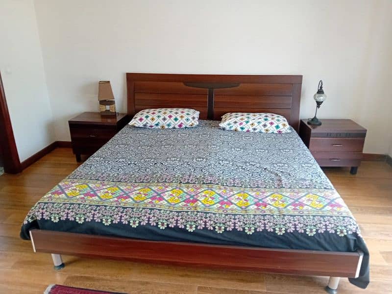 wooden beds with mattress and side tables 1