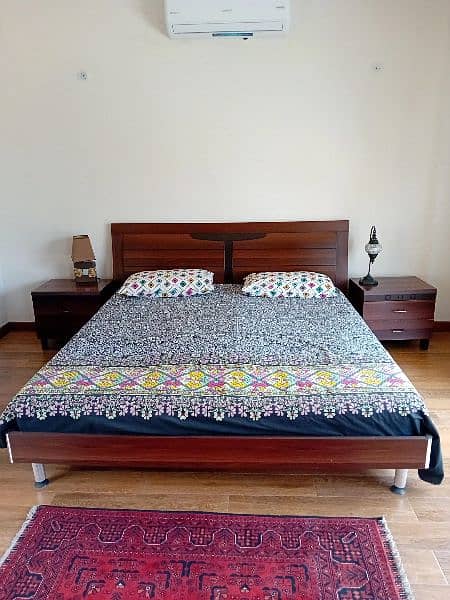 wooden beds with mattress and side tables 8