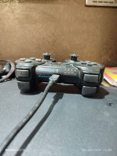 playstation 3 with 2 controller and with charger . 03200113117 3