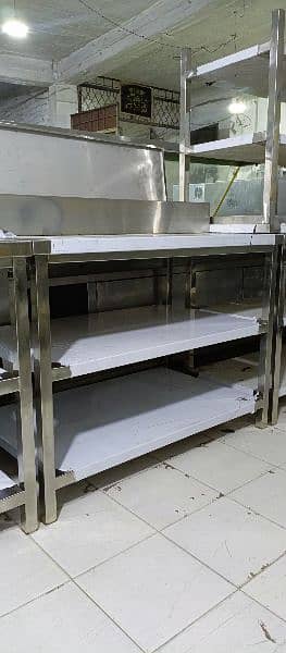 preparation table under counter shelves, deep fryer, pizza oven, avail 1