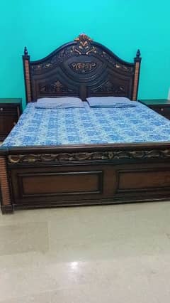 Double bed (king size) with side tables.