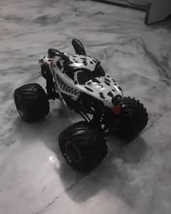 black and white dog style monster truck with huge tyres and suspension 0