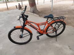 orange fast speeding bicycle with back seat and gears