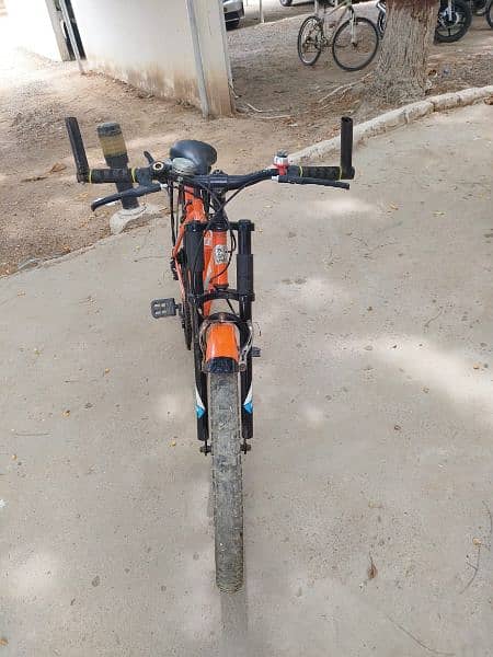 orange fast speeding bicycle with back seat and gears 1