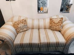 6 seater, off white and dull gold sofa.