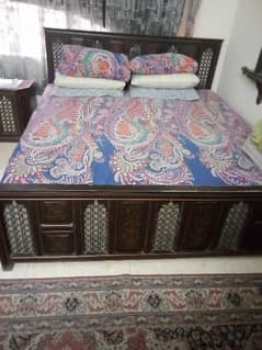 king size wooden bed and mirror