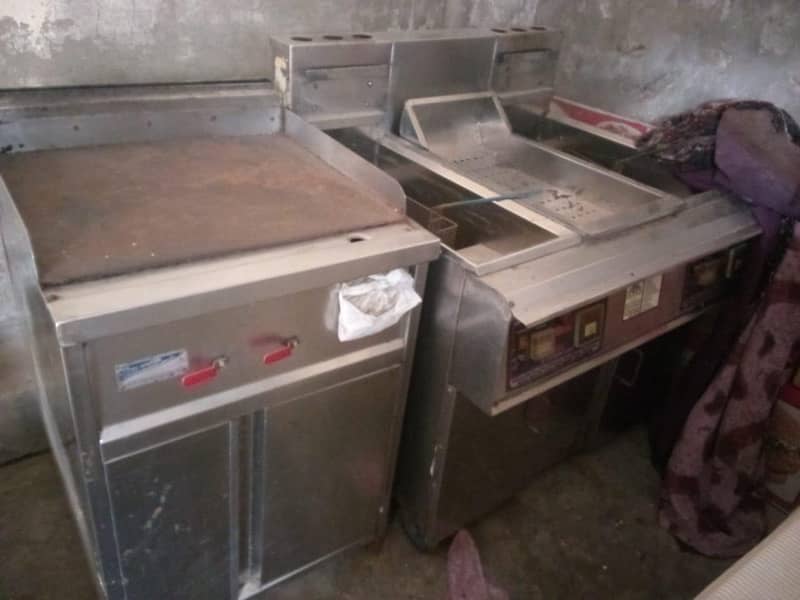 one double fryer ,one hot plate ,two working tables  ,one hote case 1