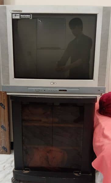 LG large Television and wooden Trolley. . 0