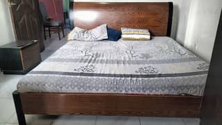 king size wooden bed with two sides