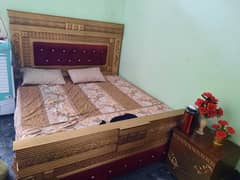 King size bed with side tables, dressing table and showcase.