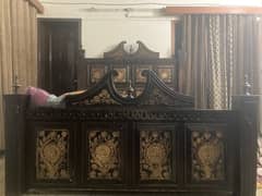 wooden bed with dressing table in rough condition