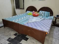 2 wooden single beds