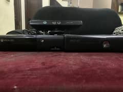 2 xbox 360 slim models with 3 controllers and one joystick