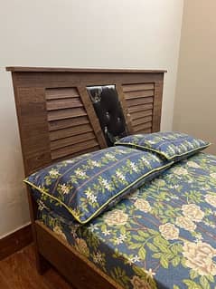 wooden bed with cupboard