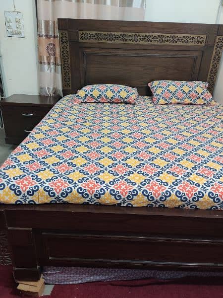 king size wooden bed with 2 side tables 2