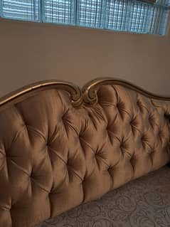 White and gold sofa with tufting