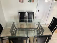 Glass top wooden dining table with 6 wooden chairs