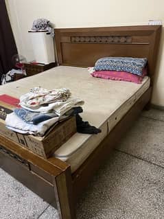 double bed with spring mattress and side tables
