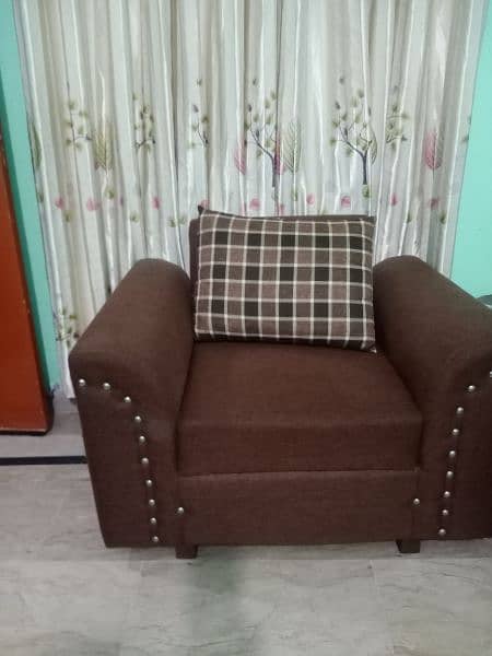 6 seater sofa in brown color in good condition with covers 1