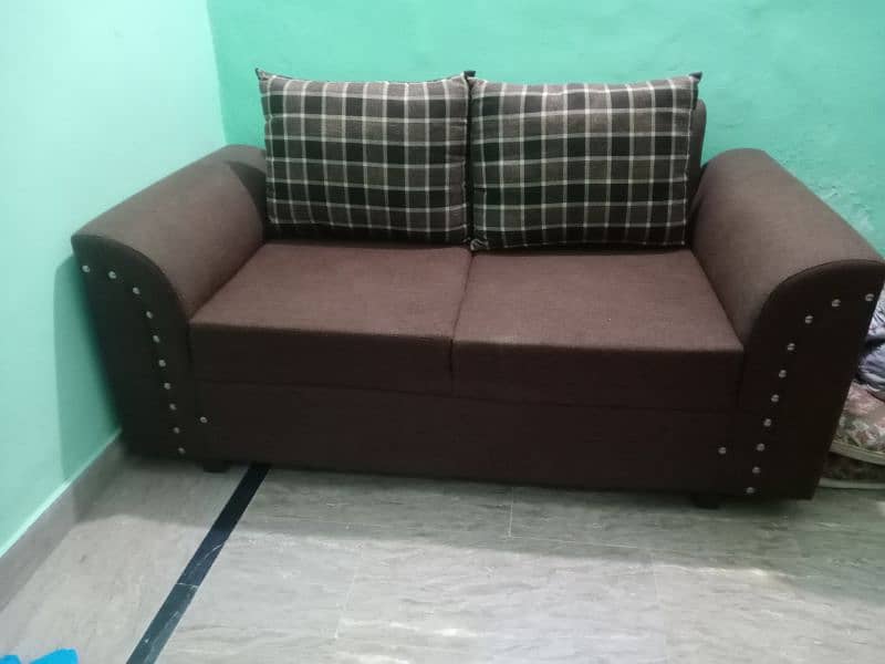 6 seater sofa in brown color in good condition with covers 3