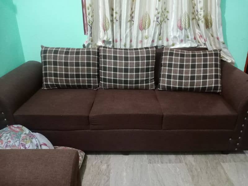 6 seater sofa in brown color in good condition with covers 4