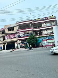 Prime Triple-Story Building for Sale on Main Round Chowk Prior to Main Gate of Marghzar Officers Housing Society with High Rental Income