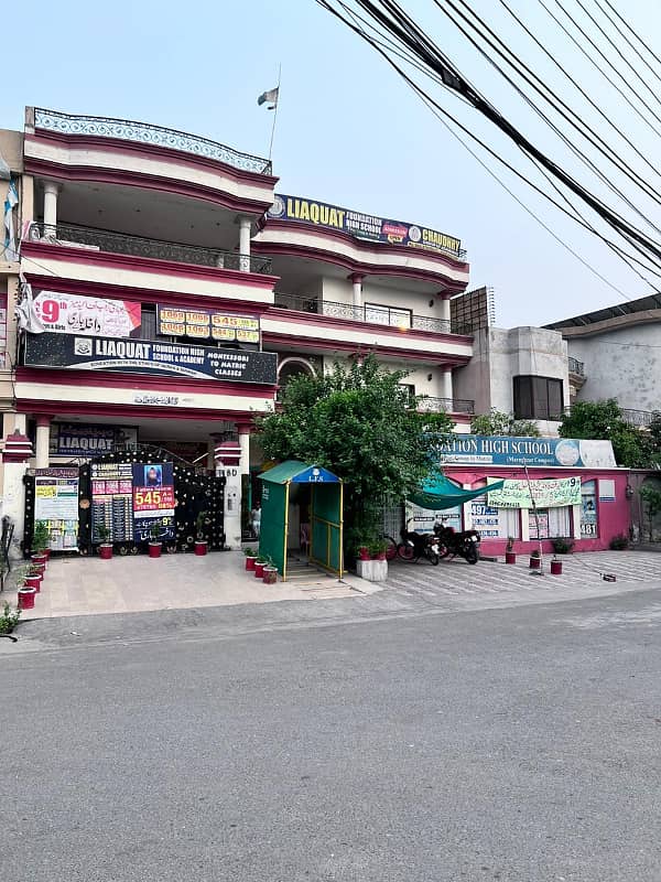 Prime Triple-Story Building for Sale on Main Round Chowk Prior to Main Gate of Marghzar Officers Housing Society with High Rental Income 1