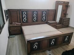 king size bed with side table and dressing table