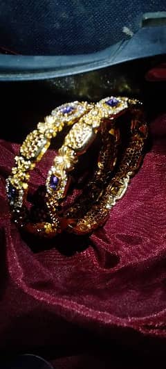 Gold colored with Purple Crystals embedded bangles