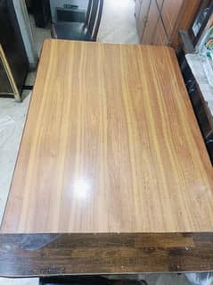 Large wooden dining table with five chairs