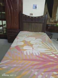 solid wooden bed with side table and mattress