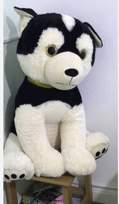 HB leisure stuffed dog black and white in color
