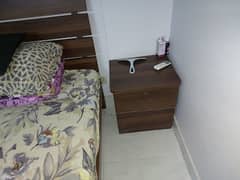 2 single beds with matresses and 1 side table