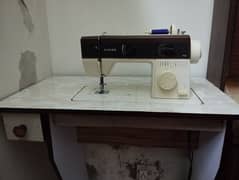 Sewing machine with table