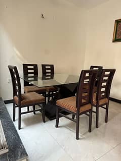 Wooden dinning table with glass top