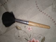 Large makeup Brush and a small eyeshadow brush.