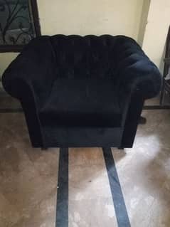 black valvat sofa with table