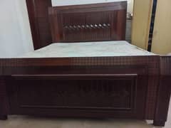 wooden bed with mattress