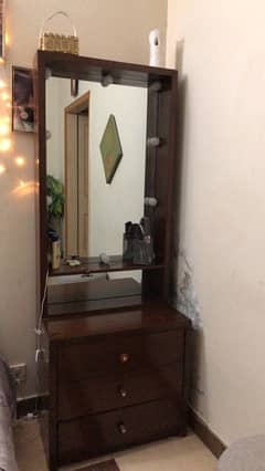 wooden dressing table with three drawers and vanity lights