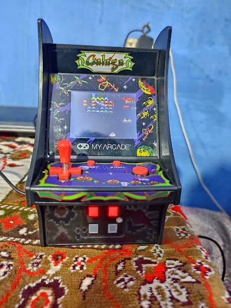 GALAGA GAME CELL OR CHARGER SE BH CHALTA HA ACHI CONDITION MAIN HA 0